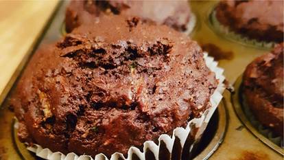chocolate zucchini muffin in muffin tin 