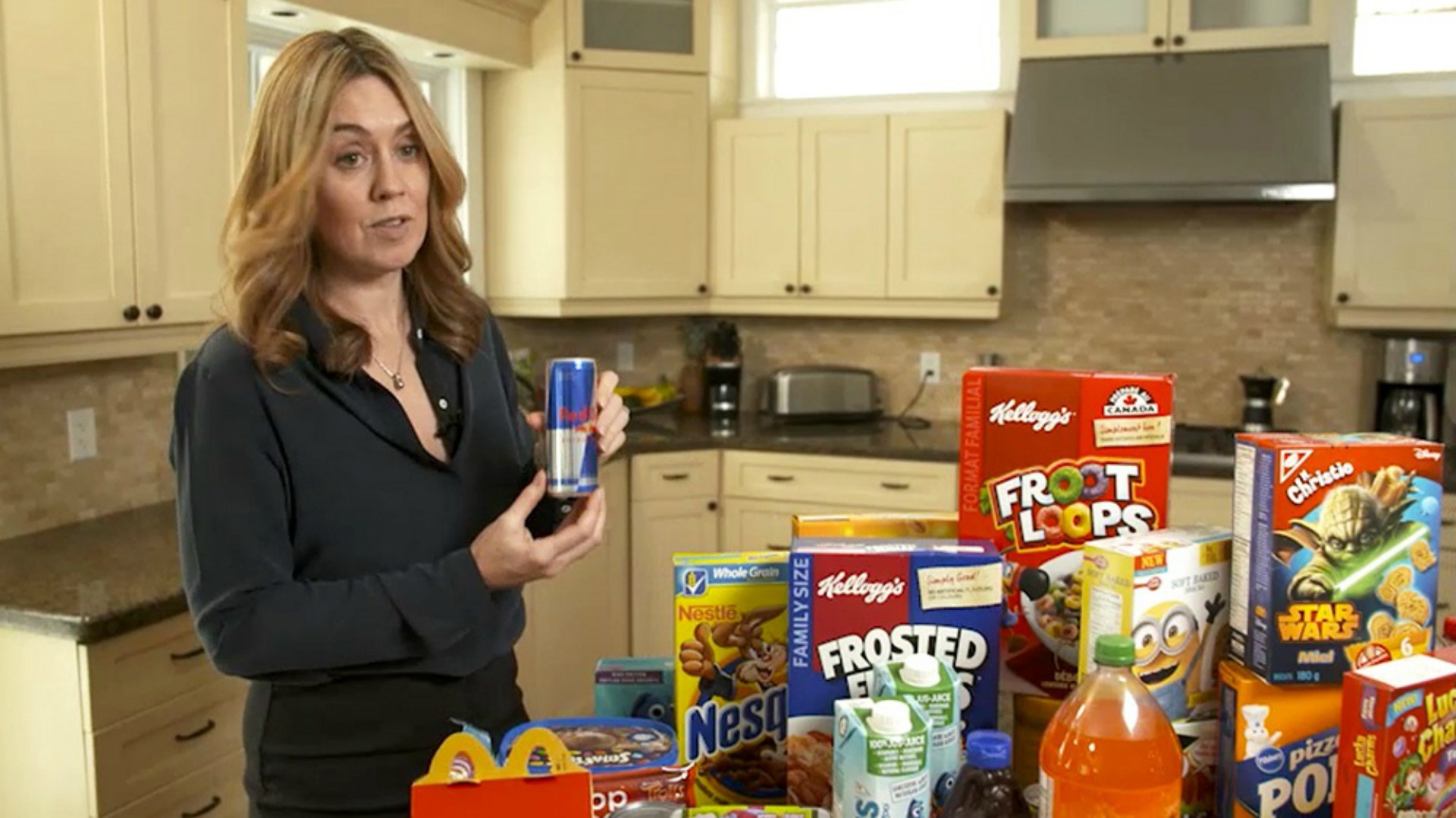 Researcher Maureen Potvin Kent displays some of the food products that are marketed to children and teens online.