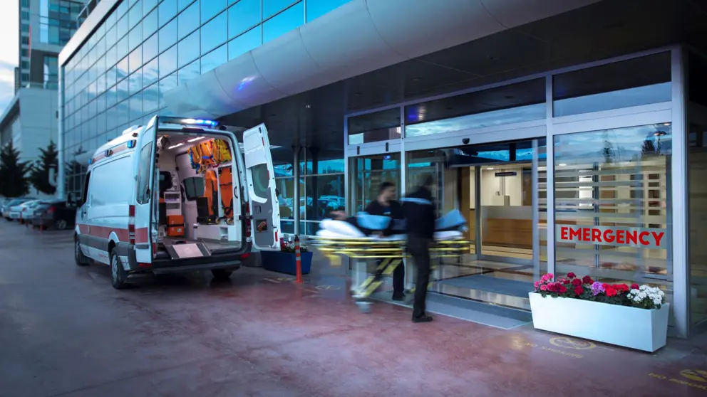 Ambulance-attendants-wheel-a-person-on-a-gurney