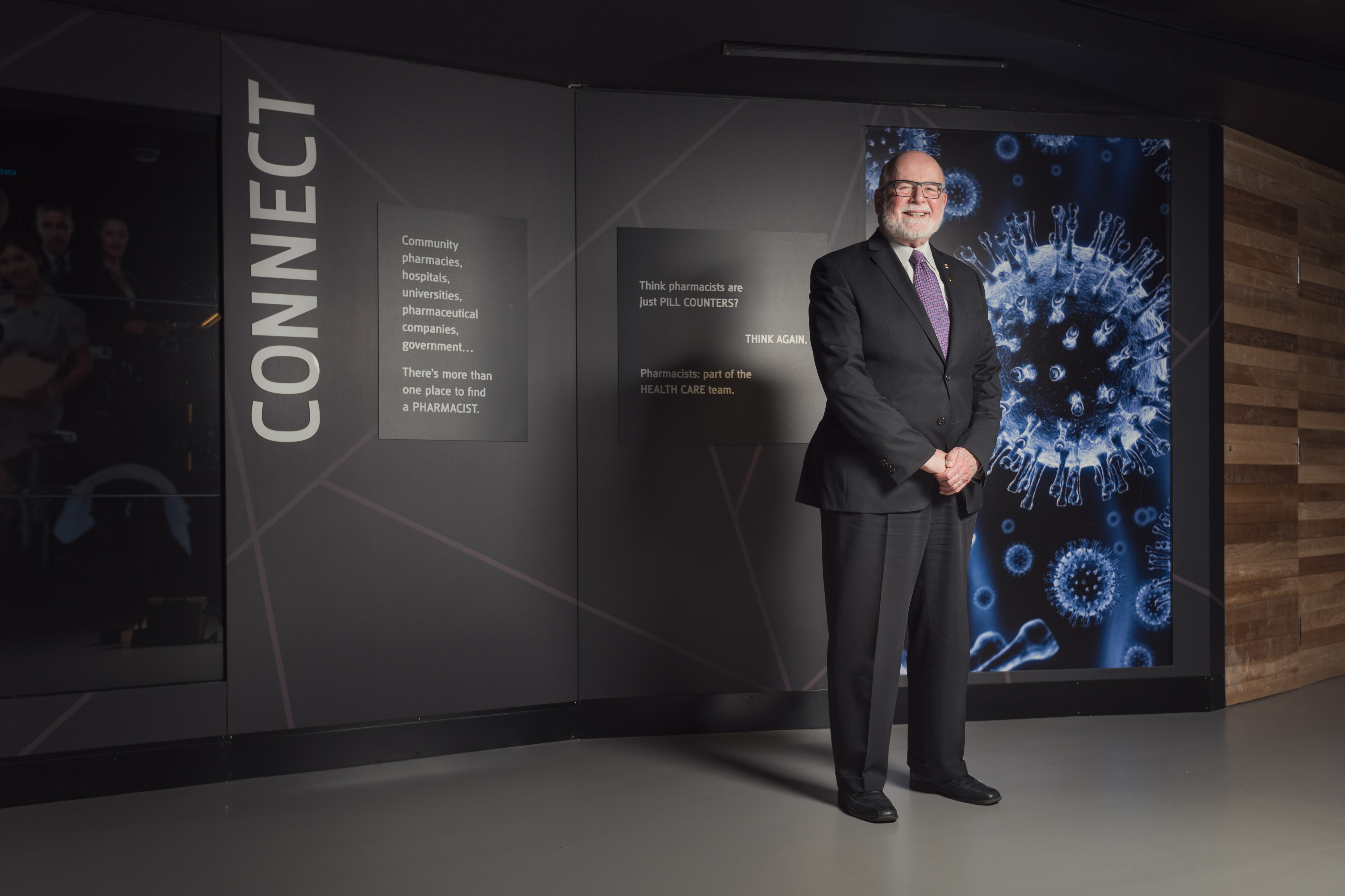Dr. John McNeill stands in front of a display.
