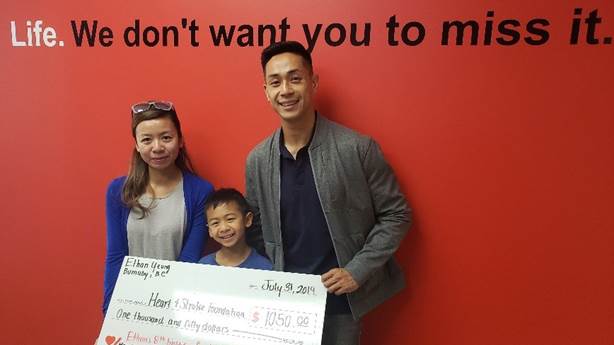 <p>Ethan Yeung and his parents presenting Heart &amp; Stroke with the money he raised.</p>