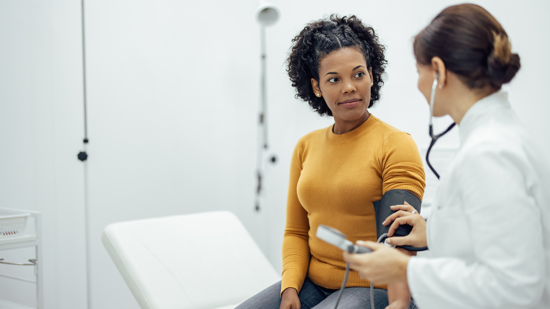 A healthcare professional checks a patient’s blood pressure