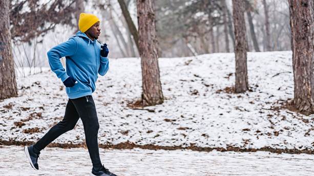 A man jogging outdoors in cold weather