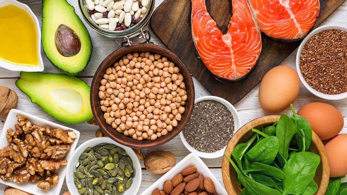 A top view of foods rich in omega-3 and other healthy fats displayed on a table.