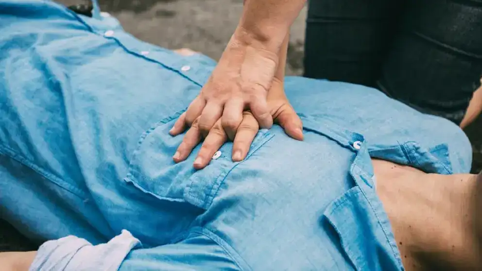 Hands doing CPR on a man’s chest