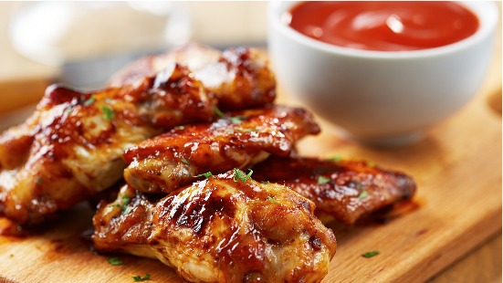 Drumsticks on a plate with barbecue sauce