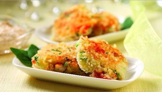 Two crab cakes on a white plate 