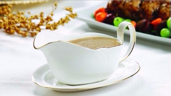 Porcini mushroom gravy in white gravy boat