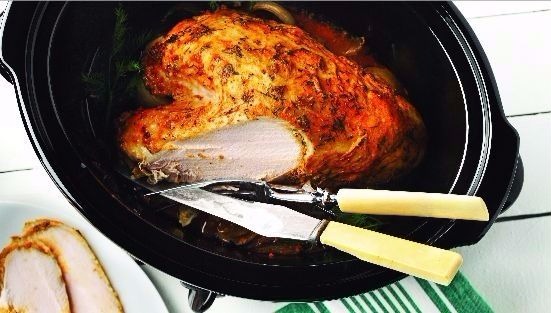 Roast turkey with dill in roasting pan 