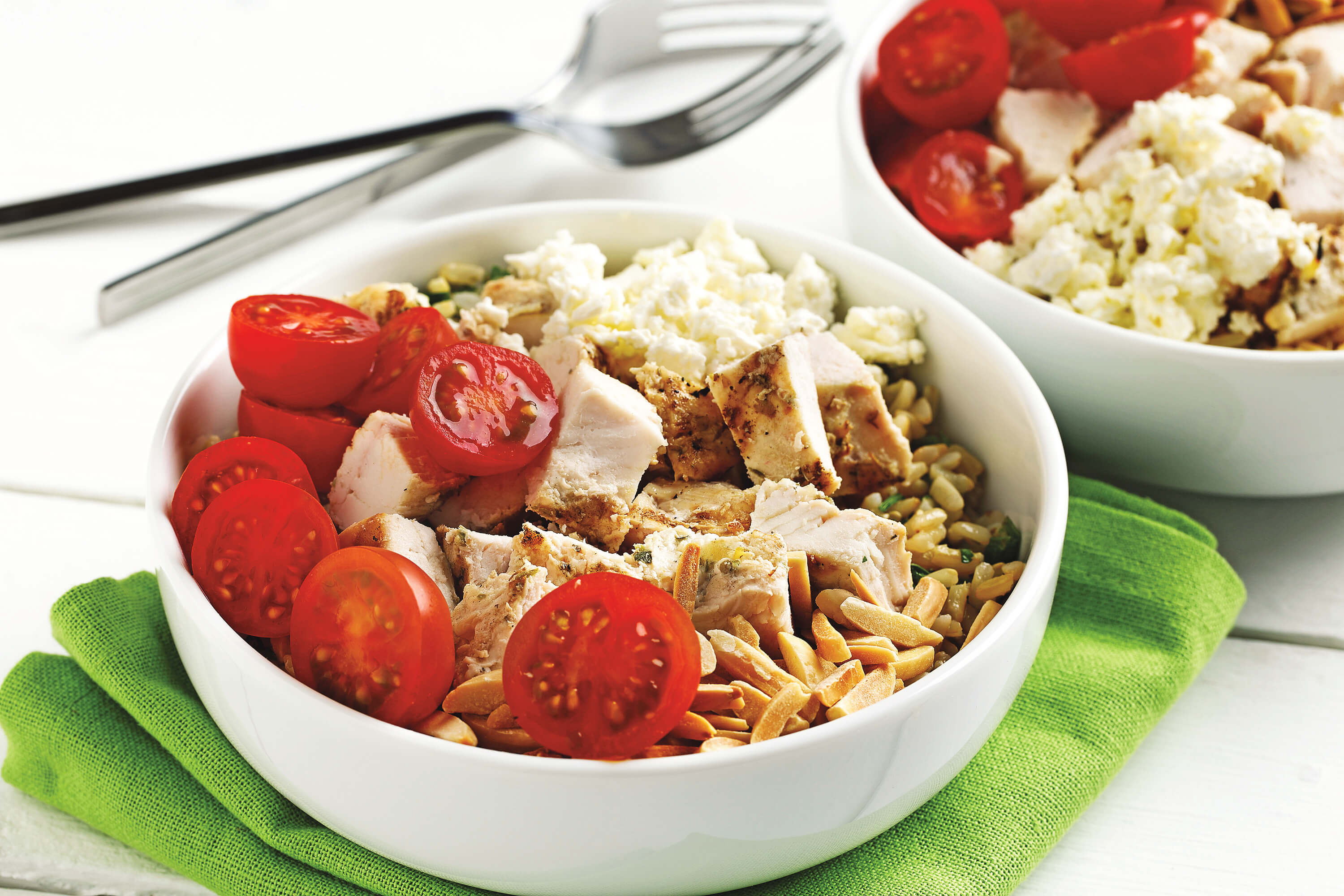 Chicken, tomatoes, feta and brown rice in a bowl