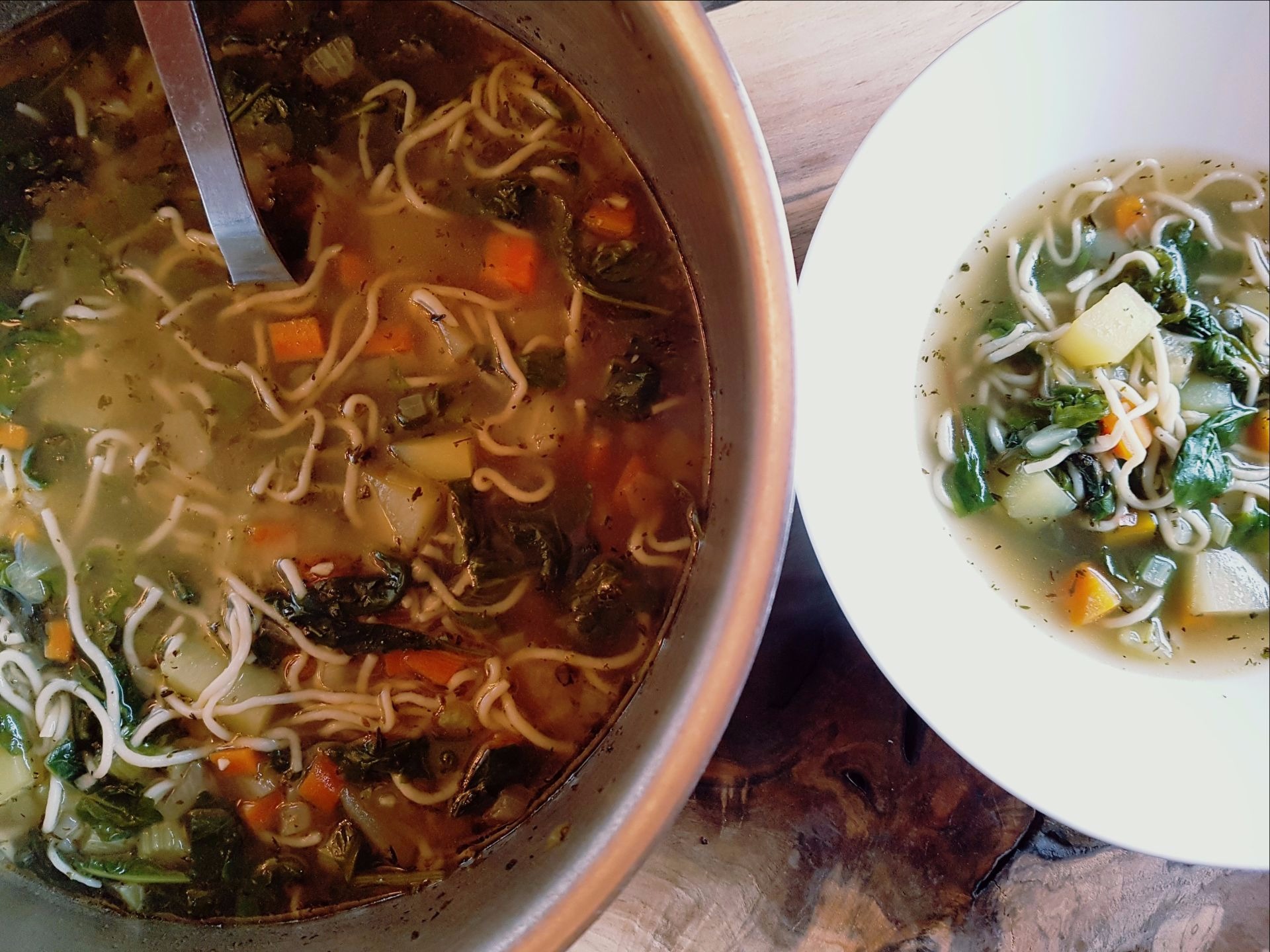 Bowl of Ramen noodles, broth, carrots, kale