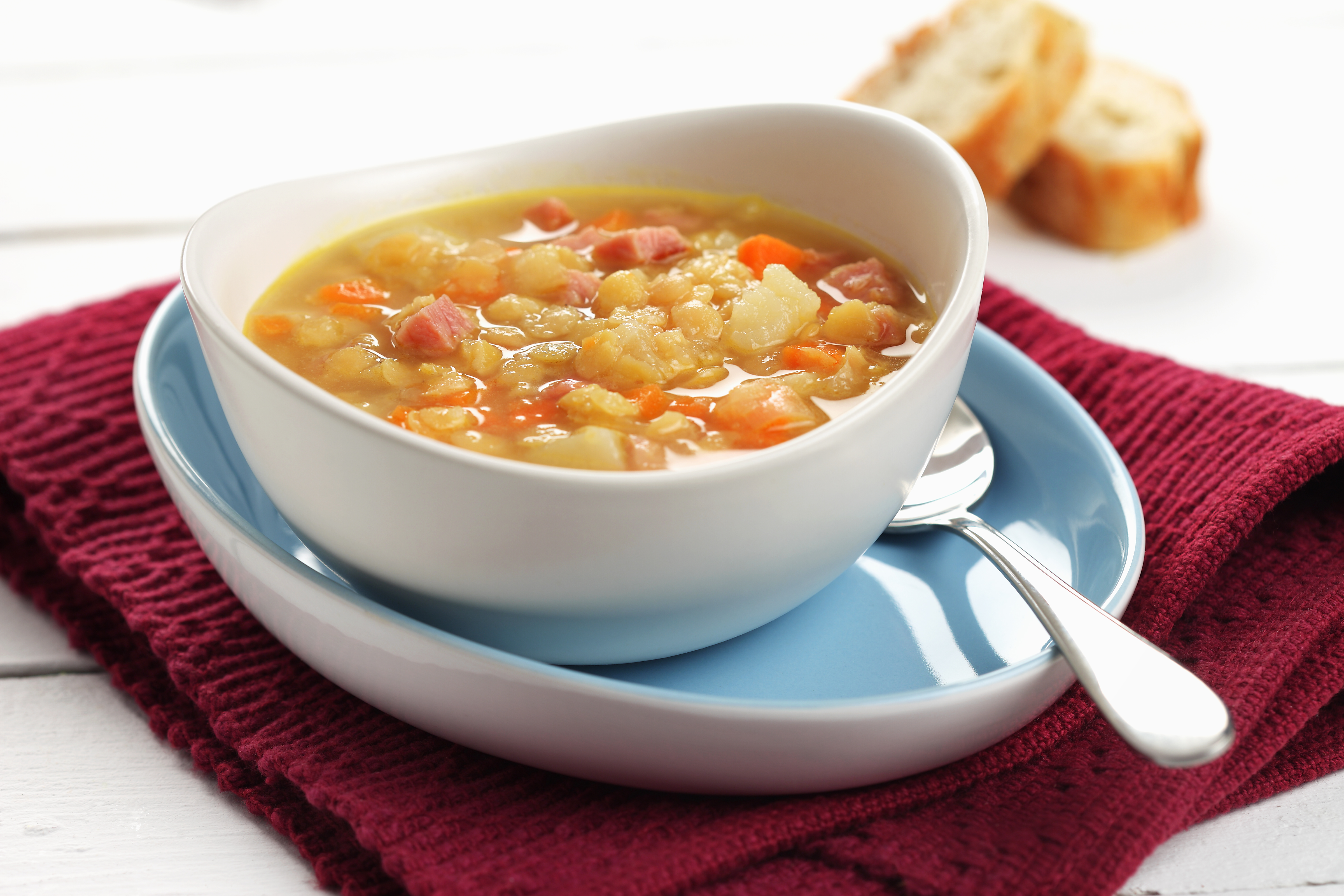 Classic split pea soup in a white bowl on a red napkin.