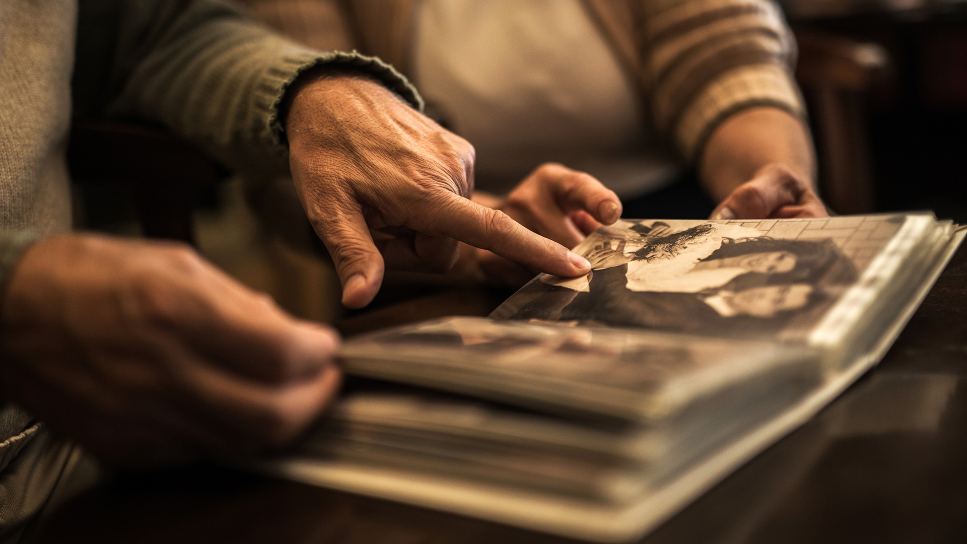 Closeup of elderly couple looking at photo album
