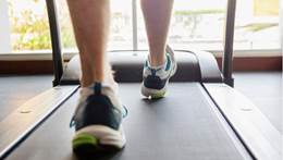 Close up of man’s feet running on treadmill