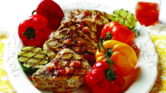 plate of pork with petite peppers, grilled zucchini and fresh ginger hot sauce