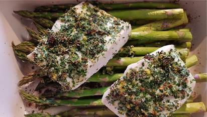 Halibut and asparagus spears in baking pan 