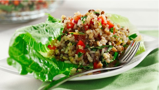 Three-grain salad with goat cheese on a lettuce leaf.