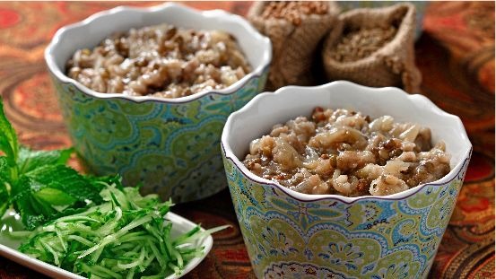 Cooked lentils and mushrooms in bowls with shredded cucumber