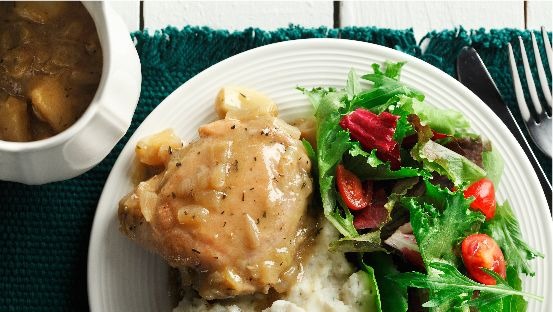 Plate with cajun garlic chicken thigh, mashed potato and salad