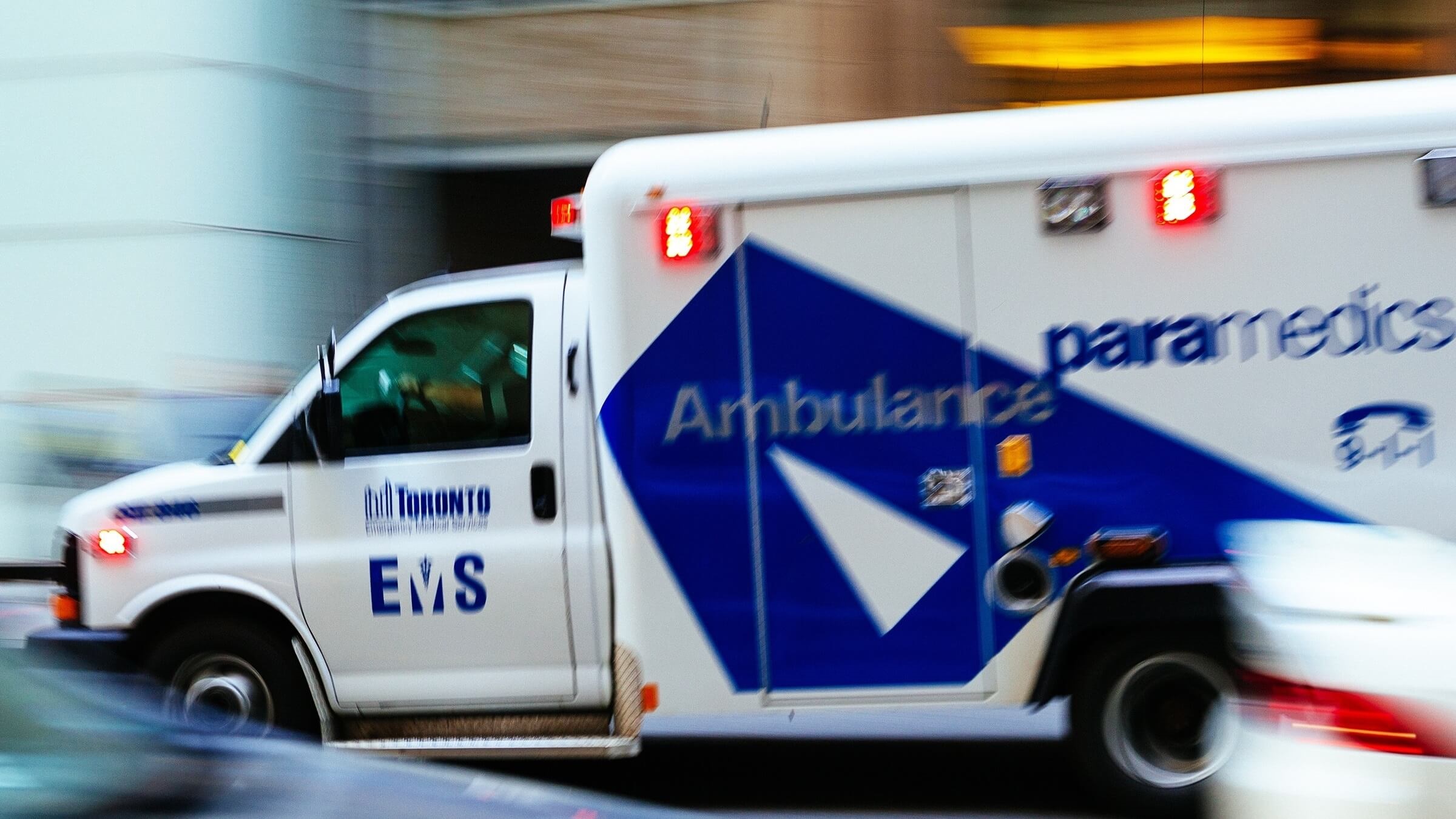 Paramedics Ambulance Toronto Emergency Medical Services EMS speeding thru traffic across the city