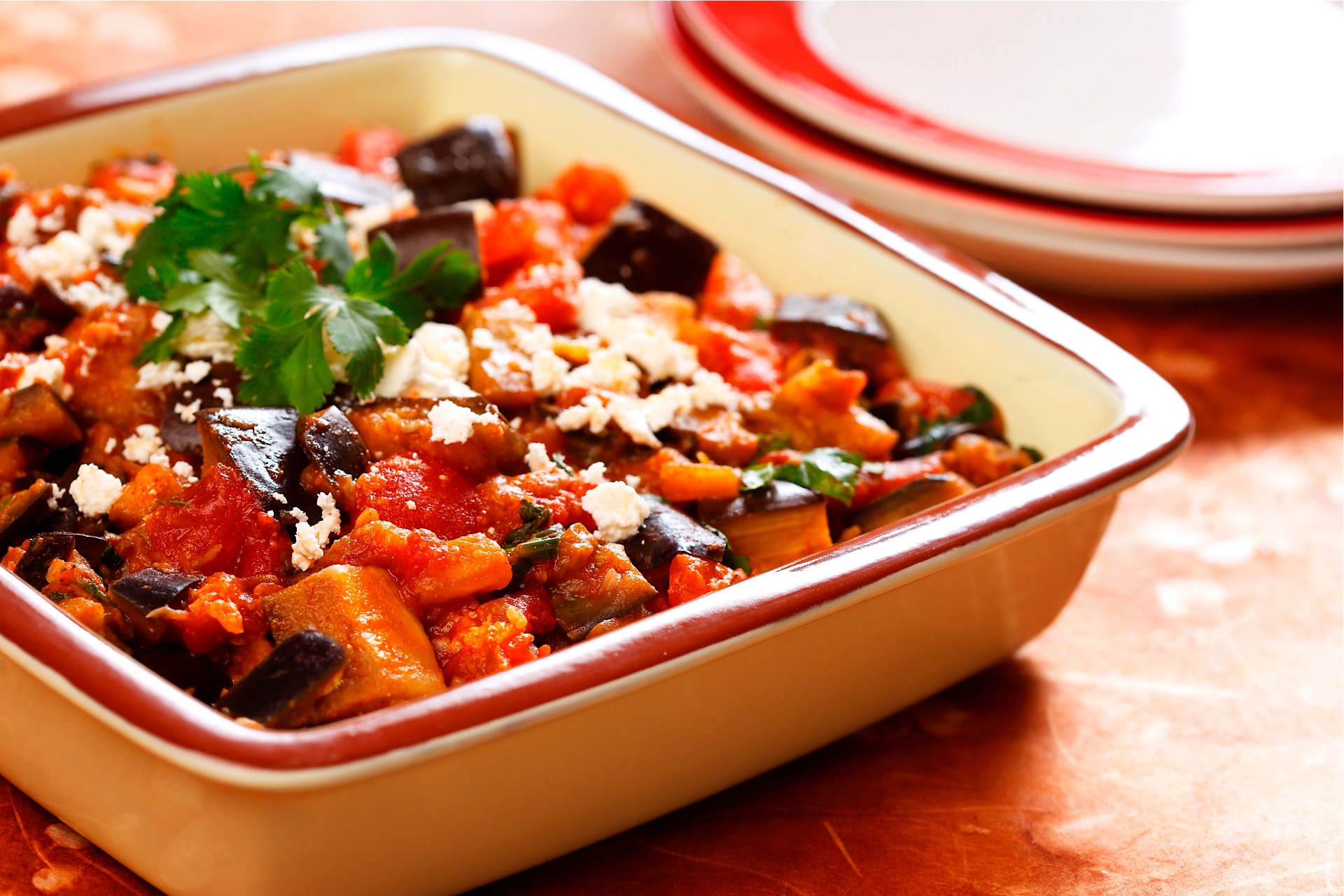 Roasted eggplant, tomatoes and feta cheese in casserole dish