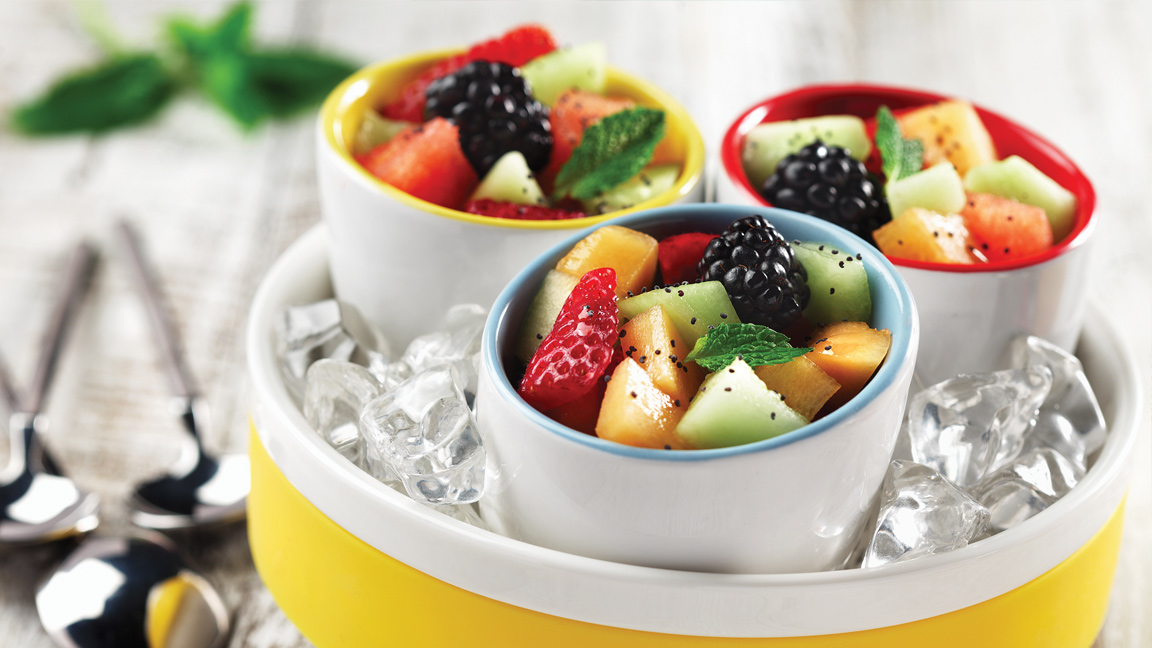 Three ramekins with diced melon, strawberries and berries