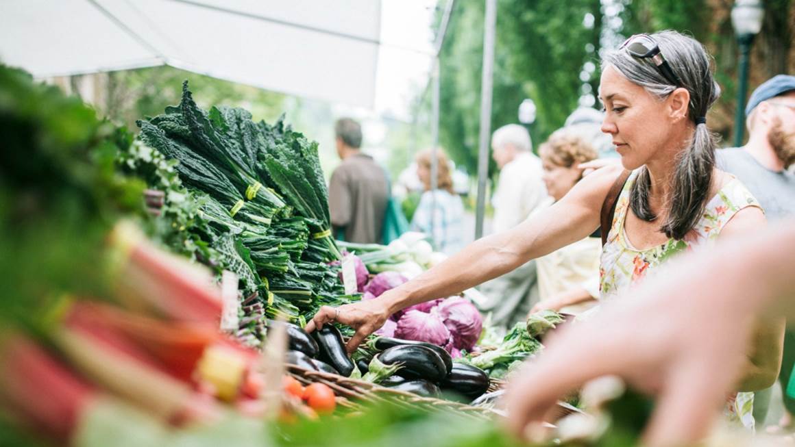 Woman shopping for vegetables at farmer's market