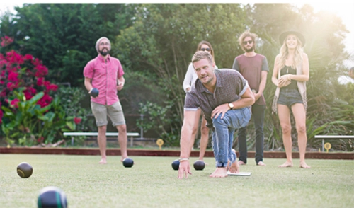 A group of people playing lawn bowling.