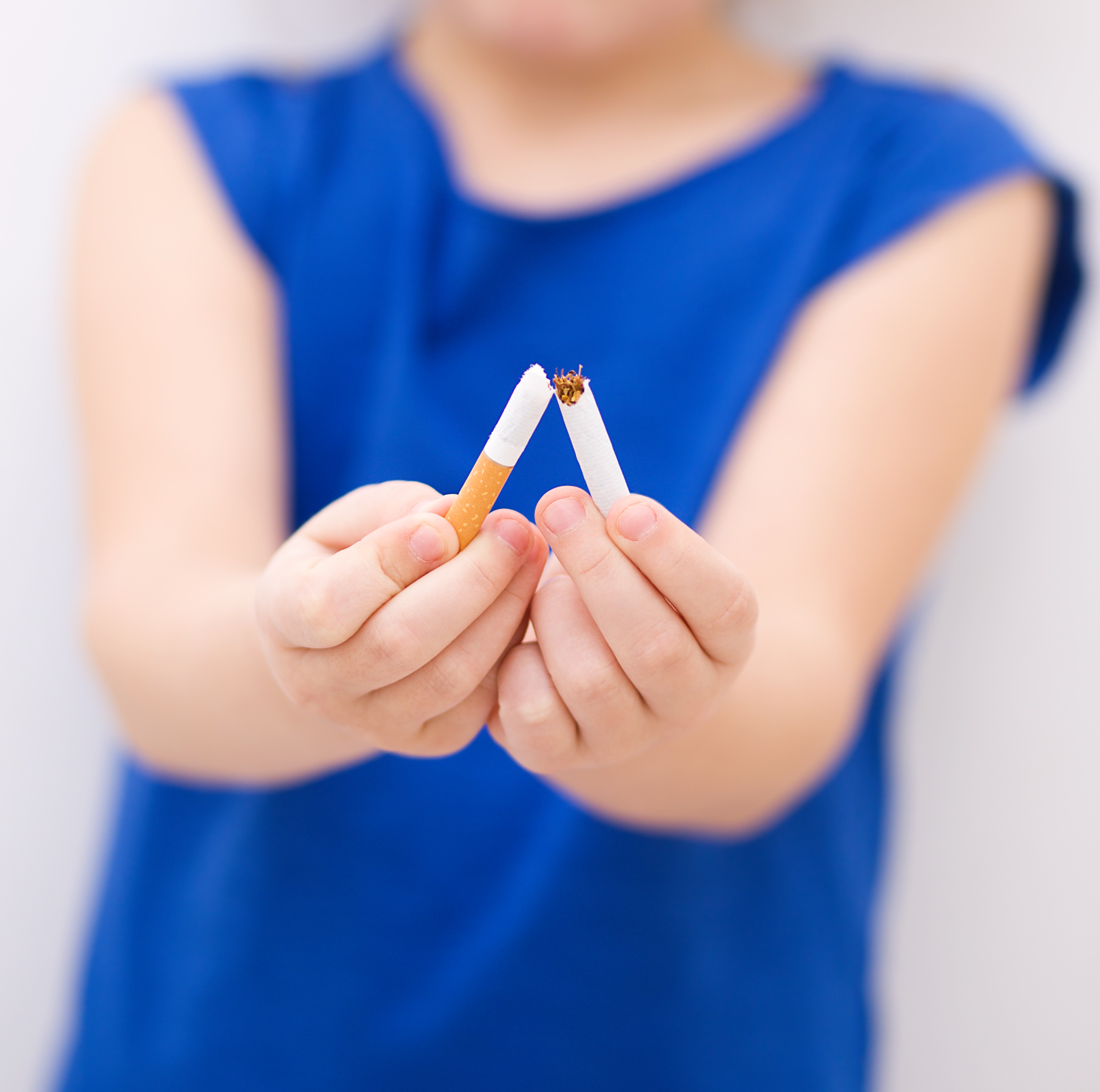 Closeup of girl breaking cigarette