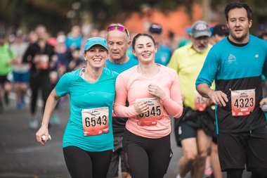 A group of adults running in a marathon