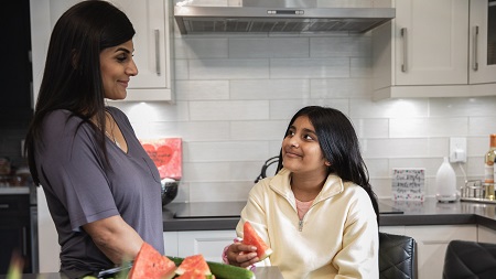 Kayla and her mom chat in the kitchen together