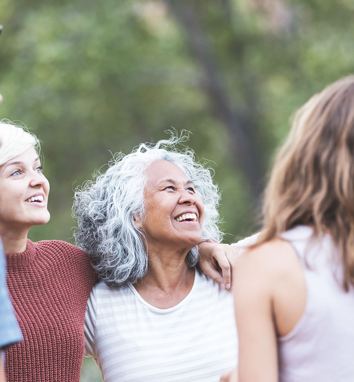 Smiling group of people talking together outdoors