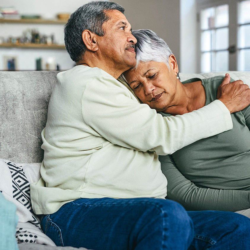 A senior man comforting his wife