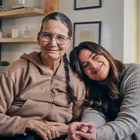 Lynne with her daughter, Shawnee Kish, smiling while holding hands.
