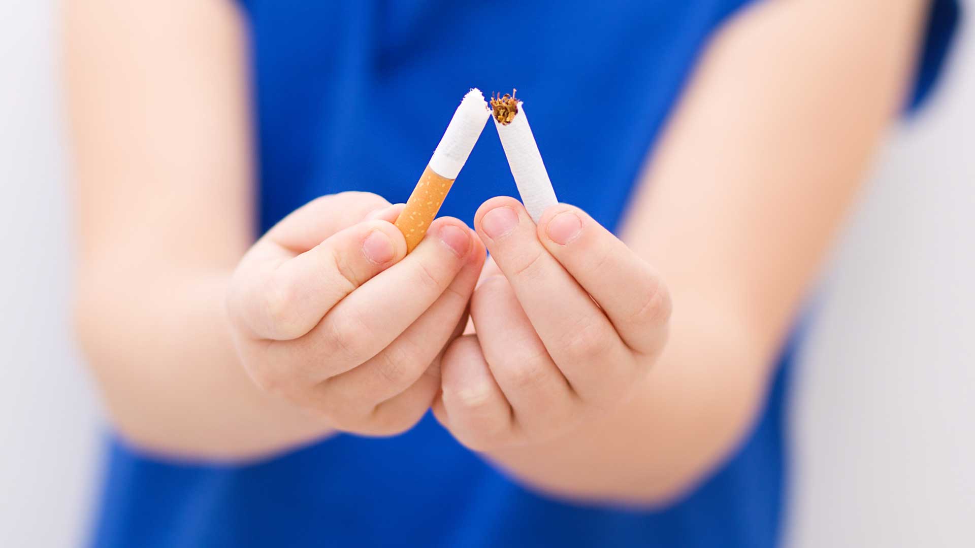 Closeup of girl breaking cigarette