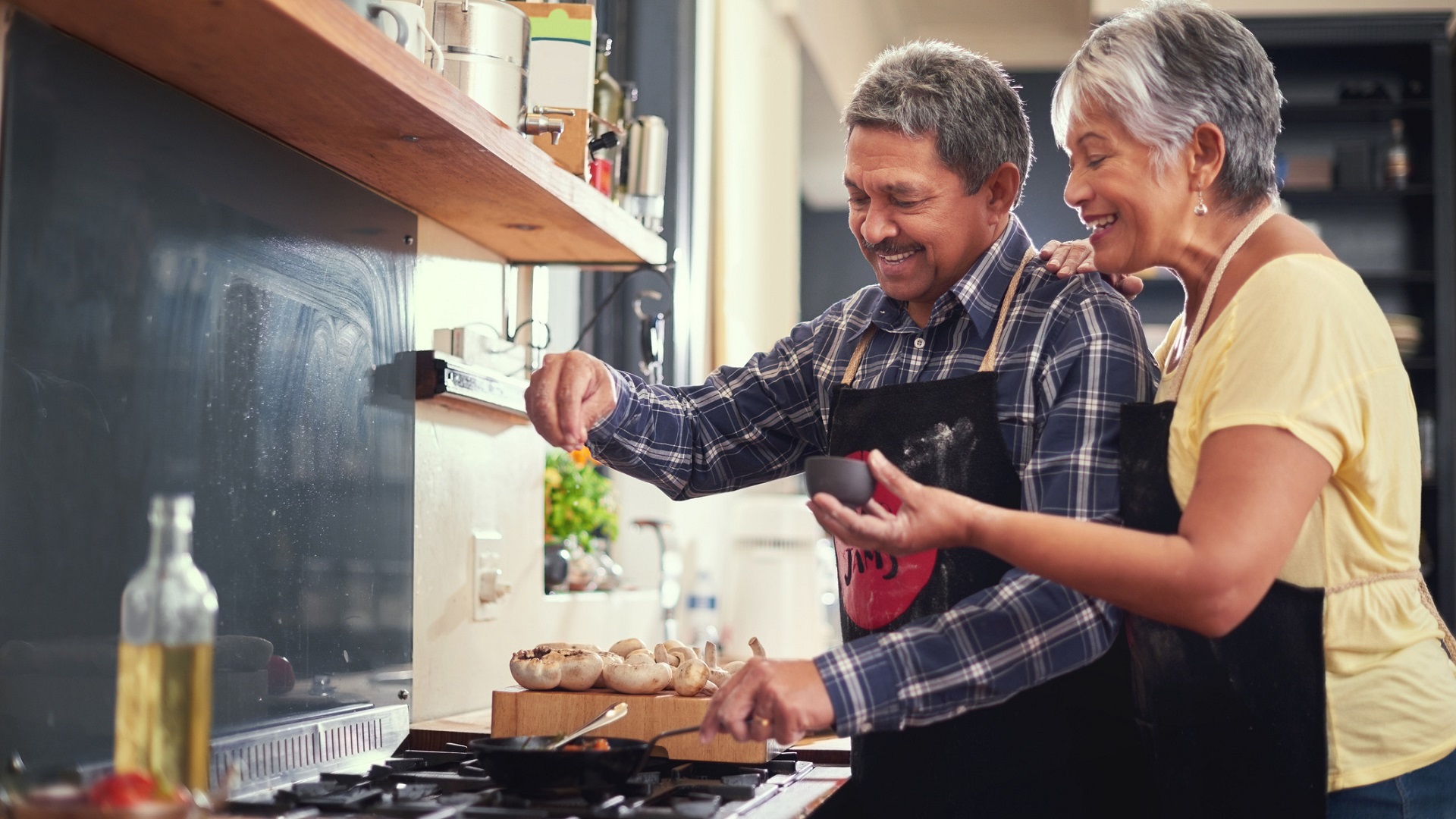 Couple cooking with salt