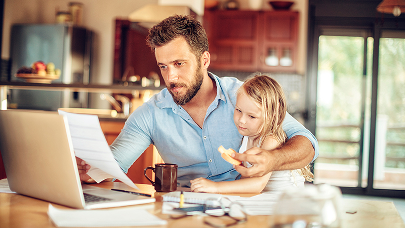 Man sitting with daughter at a computer