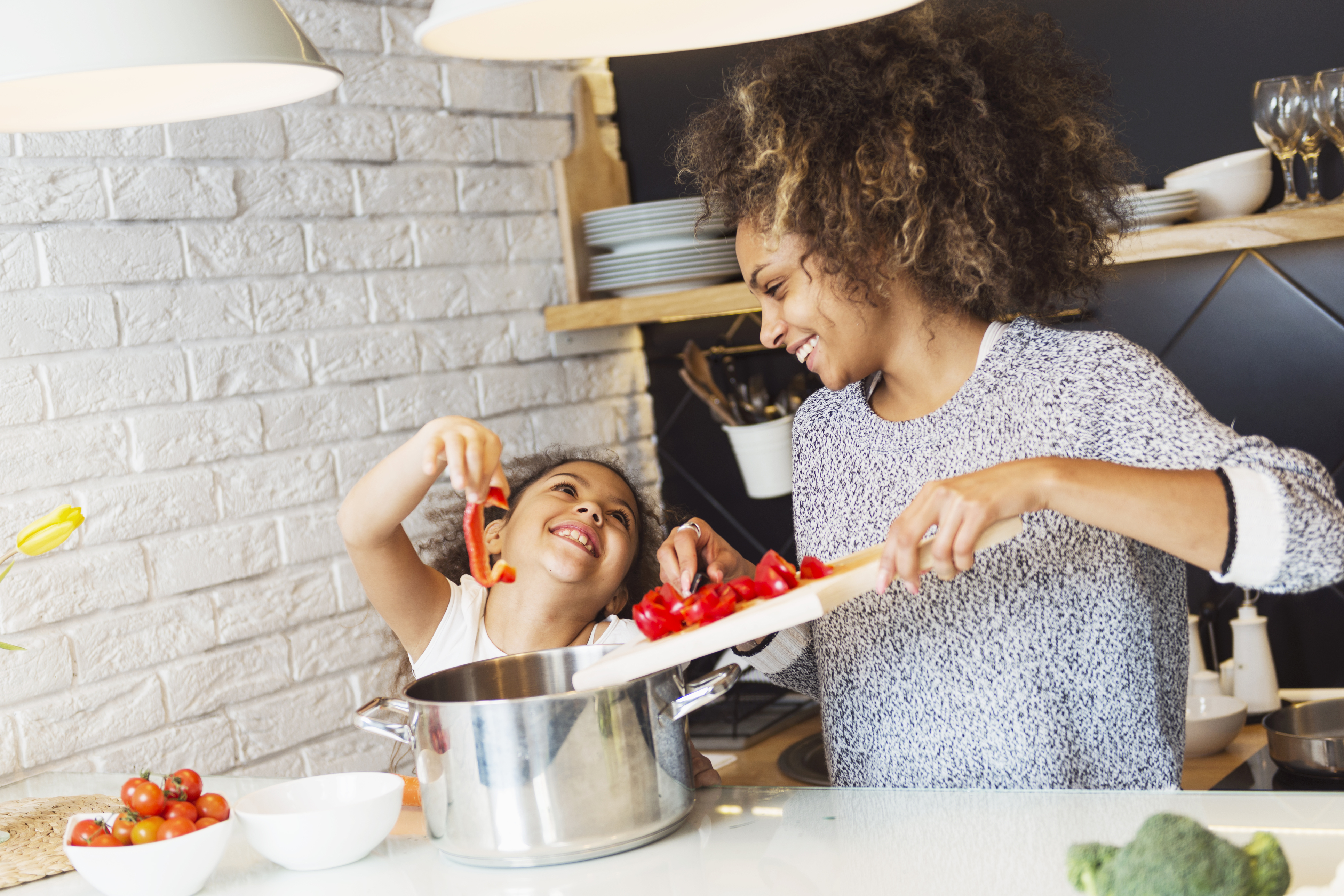 Mother and daughter cooking in kitchen