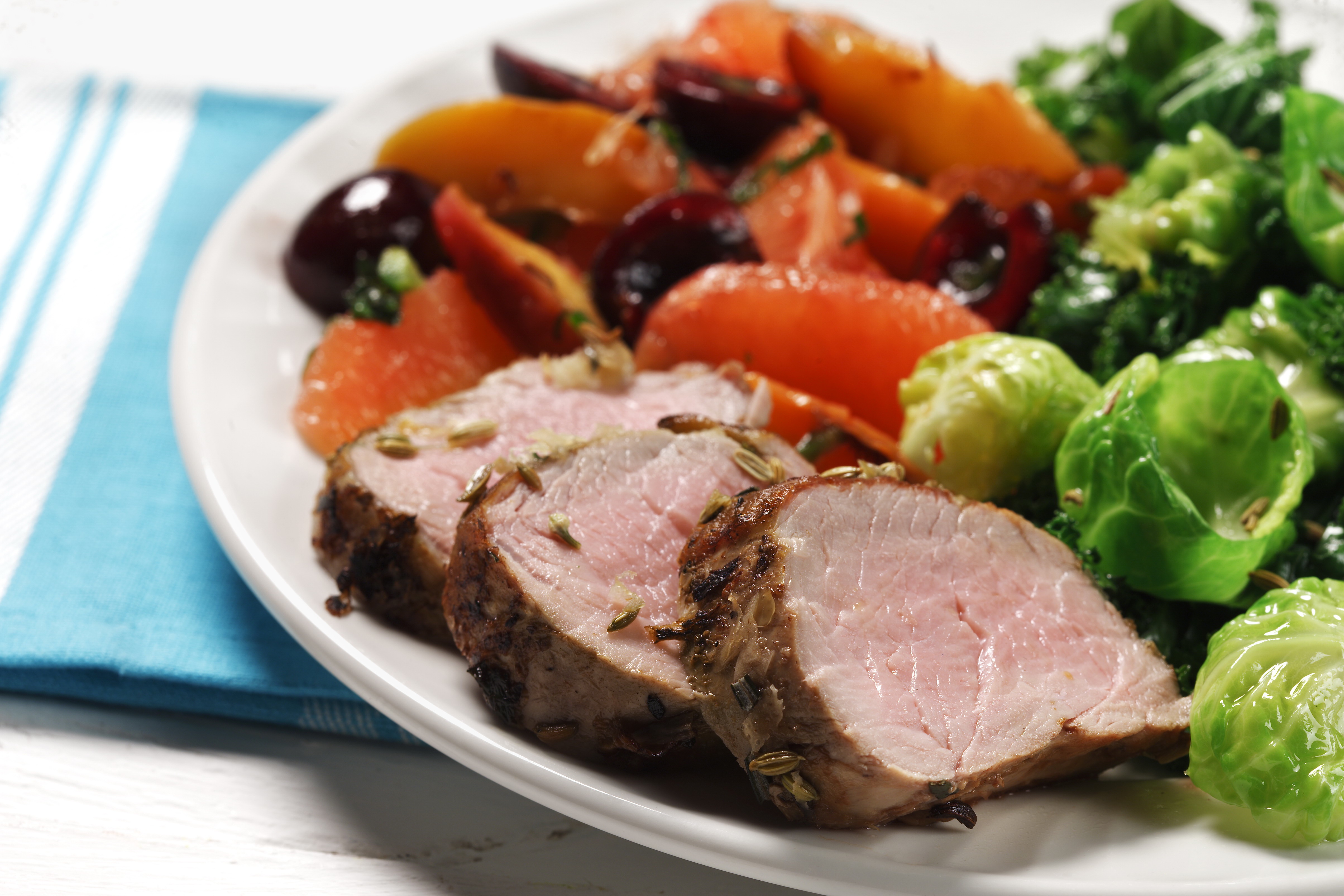 Garlic-rosemary pork tenderloin with fruit compote over greens | Heart and Stroke Foundation