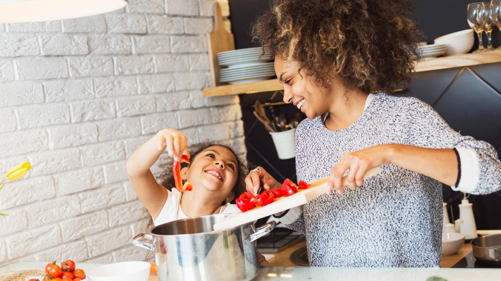 Mother and daughter cooking in kitchen