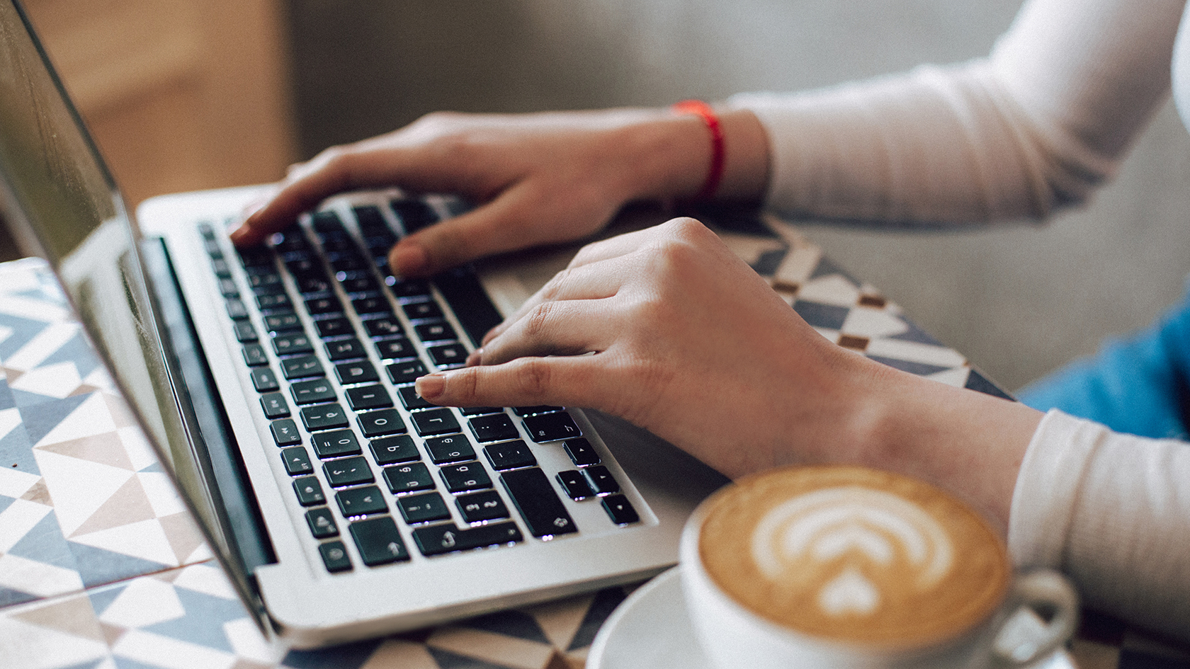 Senior woman using laptop while sitting on couch.