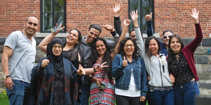A group of smiling people pose for a photo.