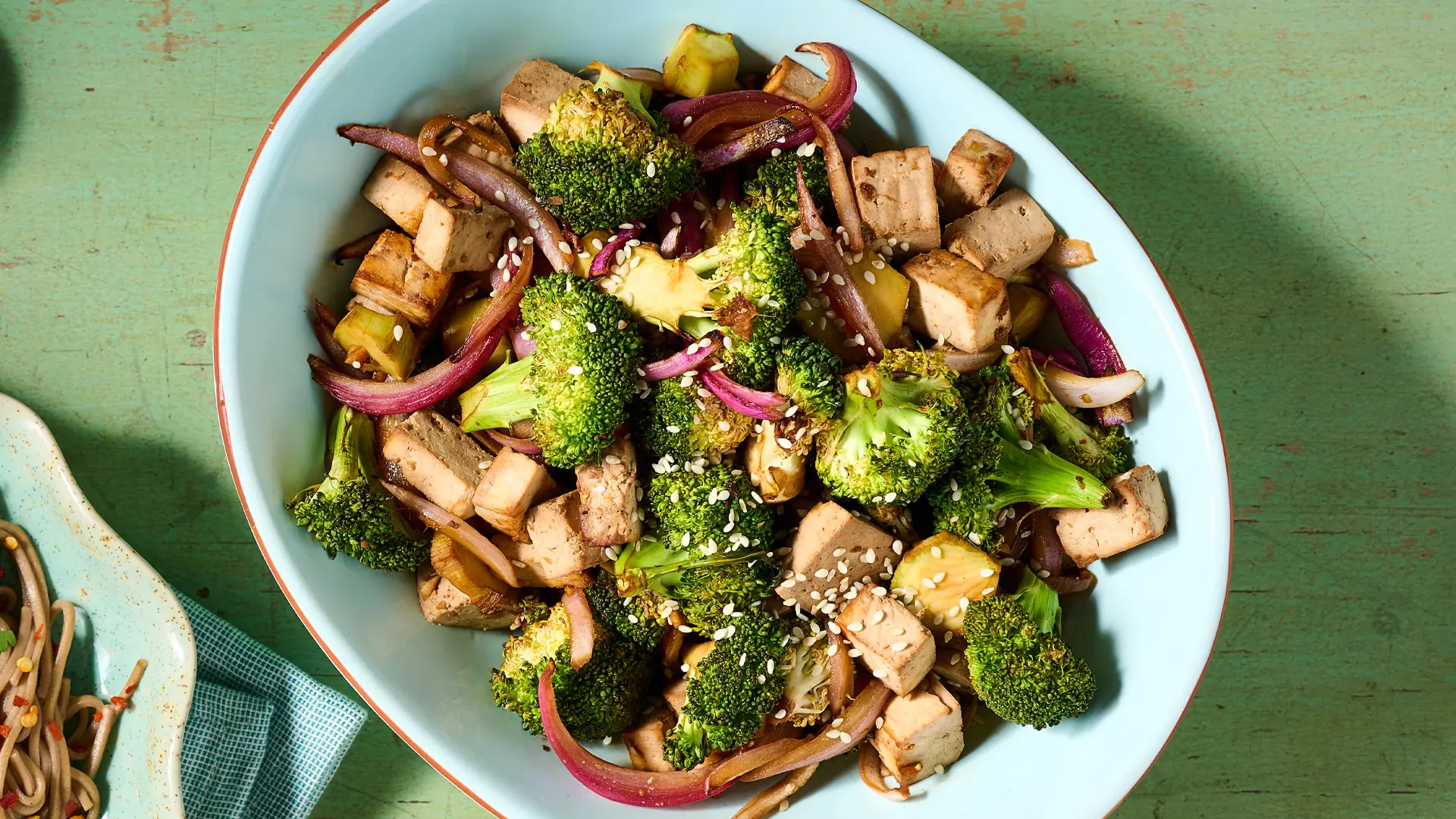 Tofu, broccoli and onion in a serving dish.