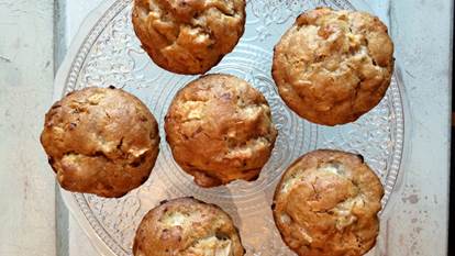 6 Apple maple cheddar muffins on a clear glass plate