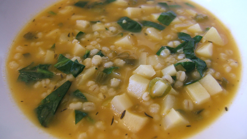 Barley and parsnip soup in a white bowl