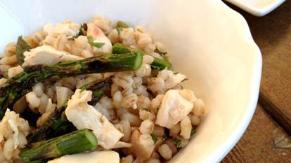 Barley asparagus chicken salad on a white plate and white bowl