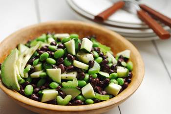 Black bean and edamame avocado salad in a wooden bowl