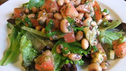 Black eyed pea and roasted garlic salad on a white plate