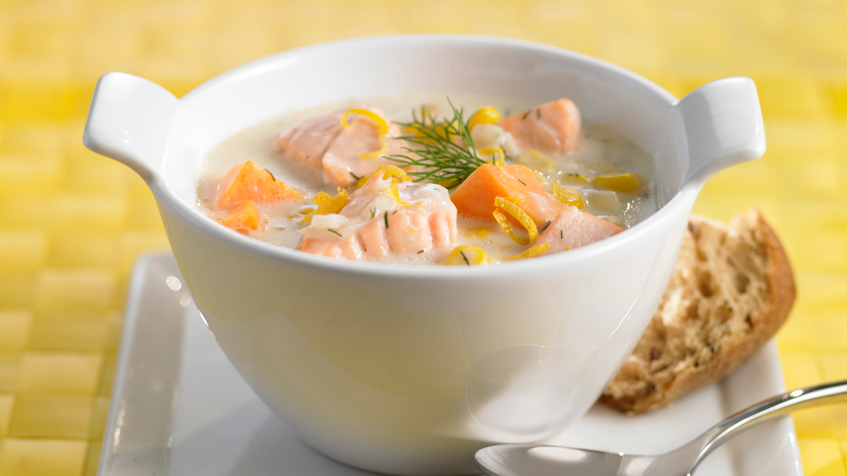 Corn sweet potato and salmon chowder in a white bowl