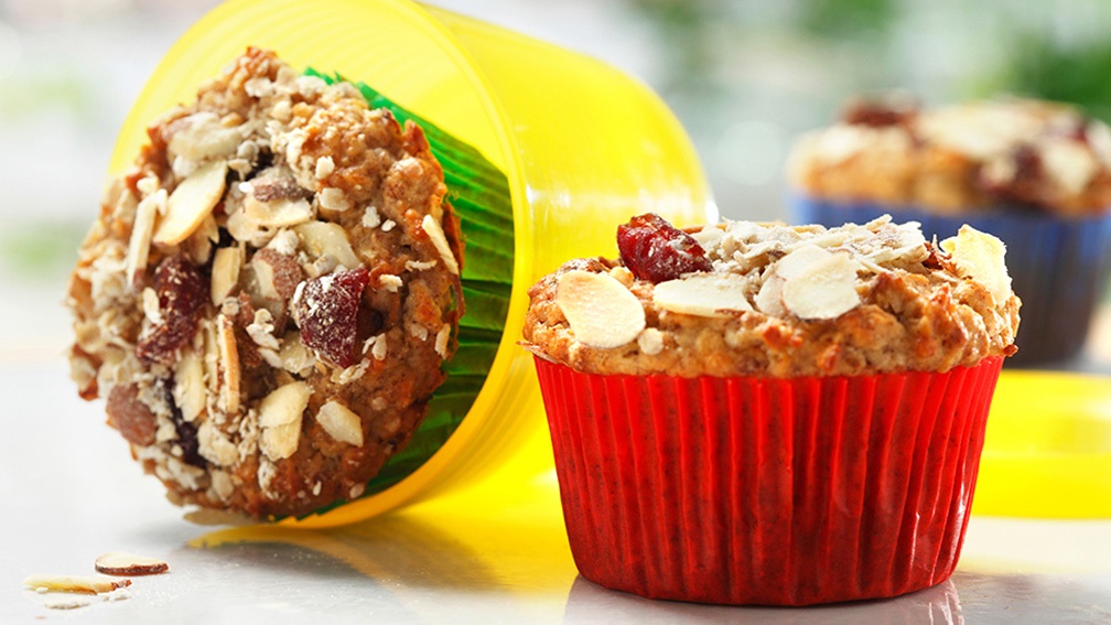 Muesli muffins with almonds and cranberries on kitchen counter